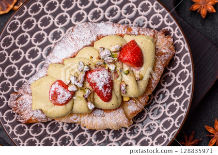 Food for breakfast sweet strawberry croissants with chocolate filling 128835971
