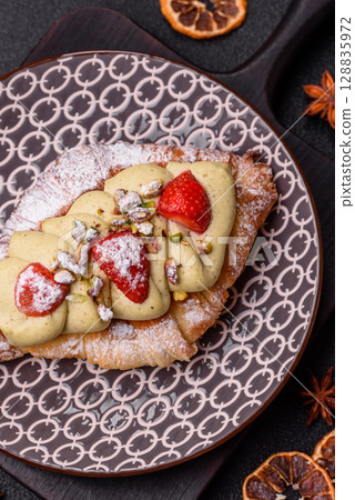 Food for breakfast sweet strawberry croissants with chocolate filling Food for breakfast sweet strawberry croissants with chocolate filling 128835972