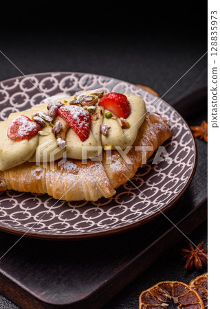 Food for breakfast sweet strawberry croissants with chocolate filling Food for breakfast sweet strawberry croissants with chocolate filling 128835973