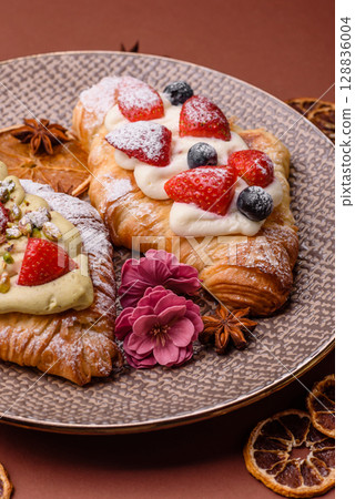 Food for breakfast sweet strawberry croissants with chocolate filling 128836004