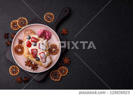 Food for breakfast sweet strawberry croissants with chocolate filling 128836023
