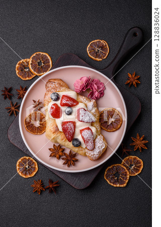 Food for breakfast sweet strawberry croissants with chocolate filling Food for breakfast sweet strawberry croissants with chocolate filling 128836024