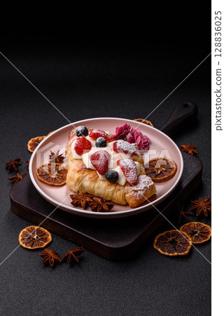 Food for breakfast sweet strawberry croissants with chocolate filling 128836025