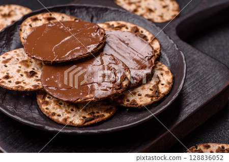 Matzah with chocolate paste for the Jewish holiday of passover 128836052
