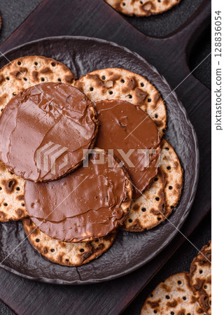 Matzah with chocolate paste for the Jewish holiday of passover Matzah with chocolate paste for the Jewish holiday of passover 128836054