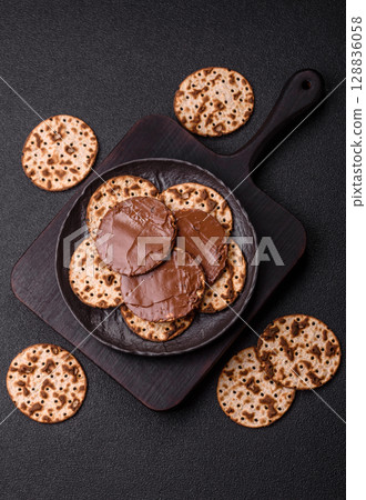Matzah with chocolate paste for the Jewish holiday of passover Matzah with chocolate paste for the Jewish holiday of passover 128836058