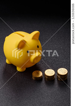 Piggy bank as a financial conceptual background with coins, doing business, saving money Piggy bank as a financial conceptual background with coins, doing business, saving money 128836086