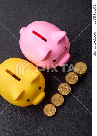 Piggy bank as a financial conceptual background with coins, doing business, saving money Piggy bank as a financial conceptual background with coins, doing business, saving money 128836101