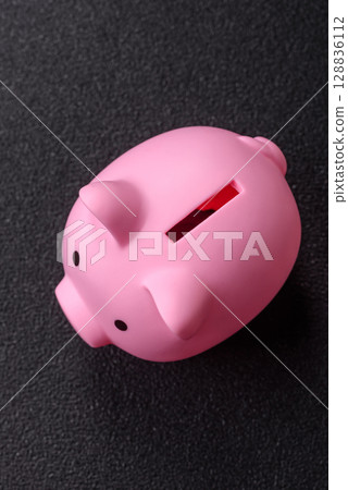 Piggy bank as a financial conceptual background with coins, doing business, saving money 128836112