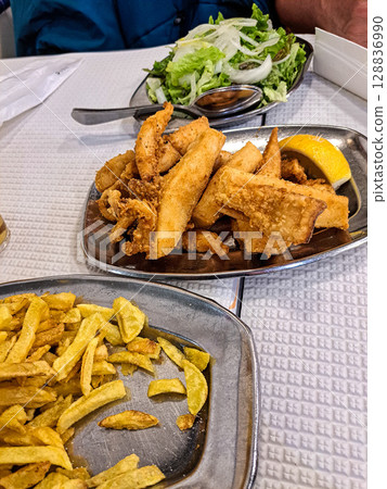 Famous O Rei do choco frito in Setubal, Portugal. Fried squid and octopus served with french fries and salad. 128836990
