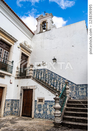 Patio and staircase with the walls decorated with cobalt-blue tiles of the House of the Holy Body in Setubal, Portugal 128836995