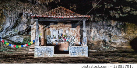 Dark interior of Lapa de Santa Margarida in Arrabida, Setubal, Portugal. Cave with small chapel of spontaneous worship Dark interior of Lapa de Santa Margarida in Arrabida, Setubal, Portugal. Cave with small chapel of spontaneous worship 128837013