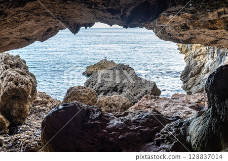 Dark interior of Lapa de Santa Margarida in Arrabida, Setubal, Portugal. Cave with small chapel of spontaneous worship Dark interior of Lapa de Santa Margarida in Arrabida, Setubal, Portugal. Cave with small chapel of spontaneous worship 128837014