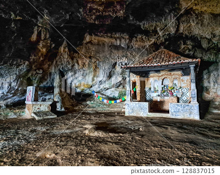Dark interior of Lapa de Santa Margarida in Arrabida, Setubal, Portugal. Cave with small chapel of spontaneous worship 128837015