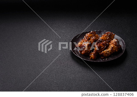 Grilled chicken wings in teriyaki sauce. Hot spicy takeaway food Grilled chicken wings in teriyaki sauce. Hot spicy takeaway food 128837406