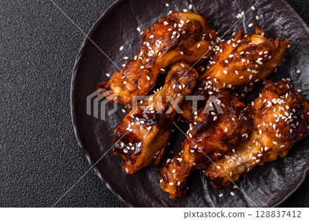 Grilled chicken wings in teriyaki sauce. Hot spicy takeaway food 128837412