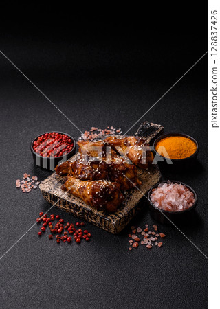 Grilled chicken wings in teriyaki sauce. Hot spicy takeaway food Grilled chicken wings in teriyaki sauce. Hot spicy takeaway food 128837426