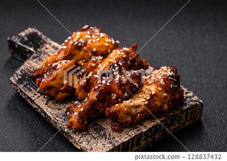 Grilled chicken wings in teriyaki sauce. Hot spicy takeaway food Grilled chicken wings in teriyaki sauce. Hot spicy takeaway food 128837432