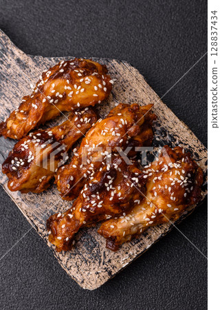 Grilled chicken wings in teriyaki sauce. Hot spicy takeaway food Grilled chicken wings in teriyaki sauce. Hot spicy takeaway food 128837434