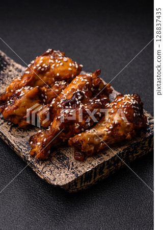 Grilled chicken wings in teriyaki sauce. Hot spicy takeaway food Grilled chicken wings in teriyaki sauce. Hot spicy takeaway food 128837435