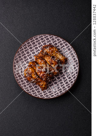 Grilled chicken wings in teriyaki sauce. Hot spicy takeaway food Grilled chicken wings in teriyaki sauce. Hot spicy takeaway food 128837442