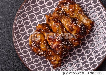 Grilled chicken wings in teriyaki sauce. Hot spicy takeaway food Grilled chicken wings in teriyaki sauce. Hot spicy takeaway food 128837445