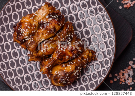 Grilled chicken wings in teriyaki sauce. Hot spicy takeaway food Grilled chicken wings in teriyaki sauce. Hot spicy takeaway food 128837448