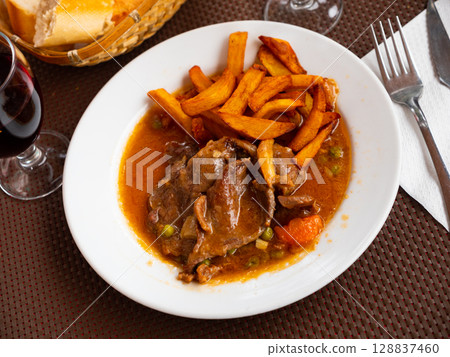 Braised beef in vegetable gravy with fried potatoes Braised beef in vegetable gravy with fried potatoes 128837460