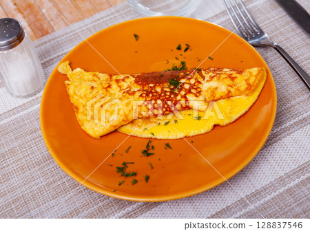 Omelet stuffed with cheese sprinkled with chopped dill Omelet stuffed with cheese sprinkled with chopped dill 128837546