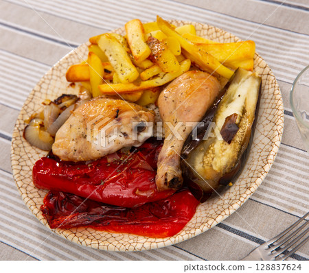 Chicken and potatoes served with vegetables 128837624