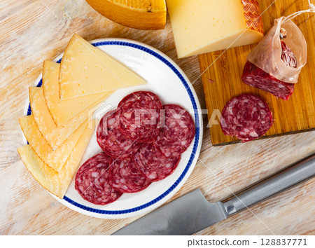 Appetizing slicing, smoked sausages and pieces of hard cheese Appetizing slicing, smoked sausages and pieces of hard cheese 128837771