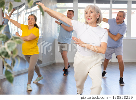 Elderly woman dances modern dances in group 128838239