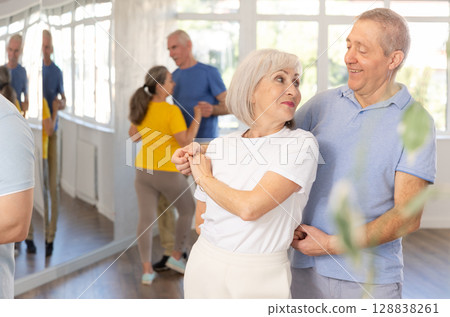 Couple of elderly man and woman dancing waltz 128838261