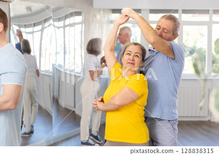 Couple of elderly man and woman dancing waltz 128838315