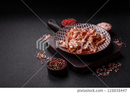 Cooked crispy bacon, slices of roast pork for an English breakfast. Fried bacon 128838447