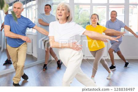 Group of aged people rehearsing sports dance in dance class 128838497