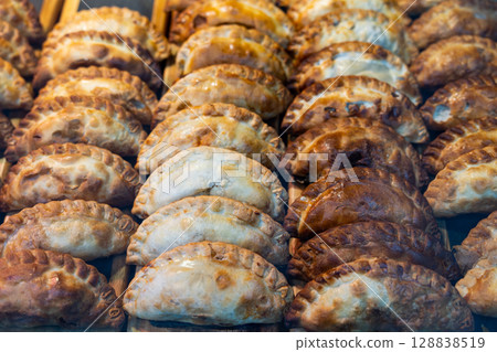 Traditional Spanish baked empanadillas presented on countertop 128838519