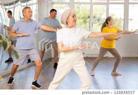 Elderly woman dances modern dances in group 128838557