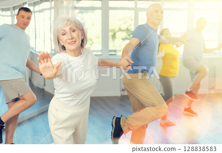 Couple of elderly man and woman dancing twist Couple of elderly man and woman dancing twist 128838583