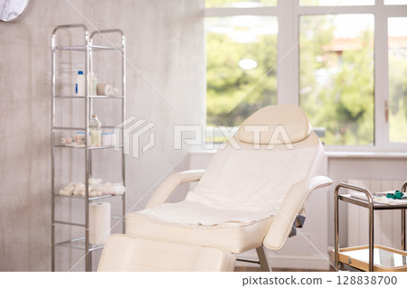 Interior of aesthetic cosmetolody clinic with chair for patient and equipment for cosmetic procedures Interior of aesthetic cosmetolody clinic with chair for patient and equipment for cosmetic procedures 128838700