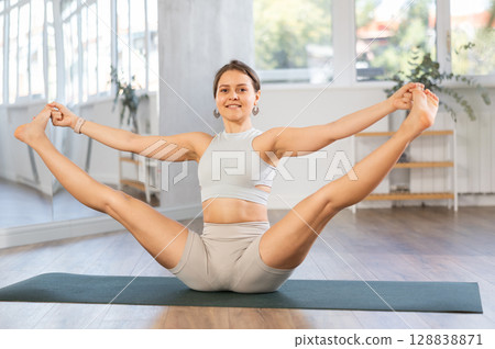 Different yoga poses performed by a slender girl in gym Different yoga poses performed by a slender girl in gym 128838871