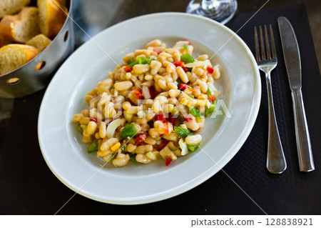 Colorful Catalan bean salad with cod and vegetables 128838921