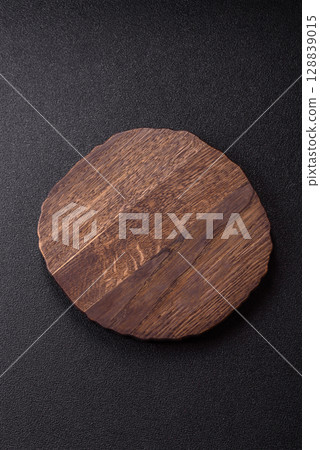 Wooden cutting board blank as a backdrop for cooking in the kitchen Wooden cutting board blank as a backdrop for cooking in the kitchen 128839015
