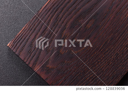 Wooden cutting board blank as a backdrop for cooking in the kitchen Wooden cutting board blank as a backdrop for cooking in the kitchen 128839036