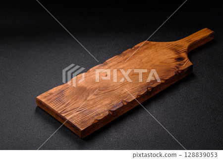 Wooden cutting board blank as a backdrop for cooking in the kitchen Wooden cutting board blank as a backdrop for cooking in the kitchen 128839053