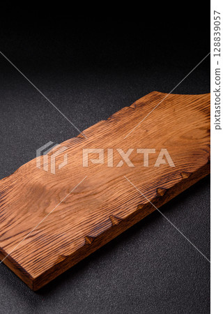 Wooden cutting board blank as a backdrop for cooking in the kitchen 128839057