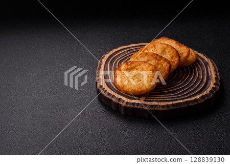 Potato hash browns, a meal with onions, cabbage in the form of fritters 128839130