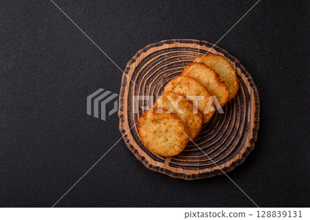 Potato hash browns, a meal with onions, cabbage in the form of fritters Potato hash browns, a meal with onions, cabbage in the form of fritters 128839131