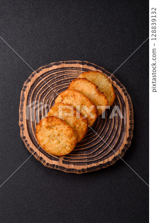 Potato hash browns, a meal with onions, cabbage in the form of fritters 128839132