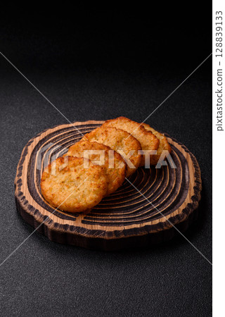 Potato hash browns, a meal with onions, cabbage in the form of fritters Potato hash browns, a meal with onions, cabbage in the form of fritters 128839133